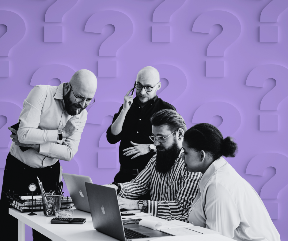 Confused looking tech workers on their laptops with question marks in the background.