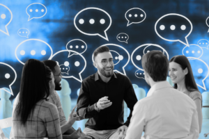 Employees sitting at a table, smiling and talking.