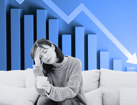 Woman sitting on a couch with her energy drained. She is feeling burned out.