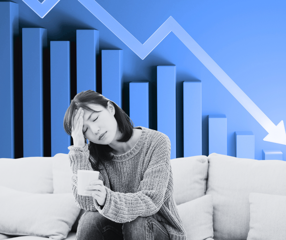 Woman sitting on a couch with her energy drained. She is feeling burned out.