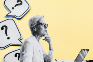 Woman sitting at a computer desk thinking about something.