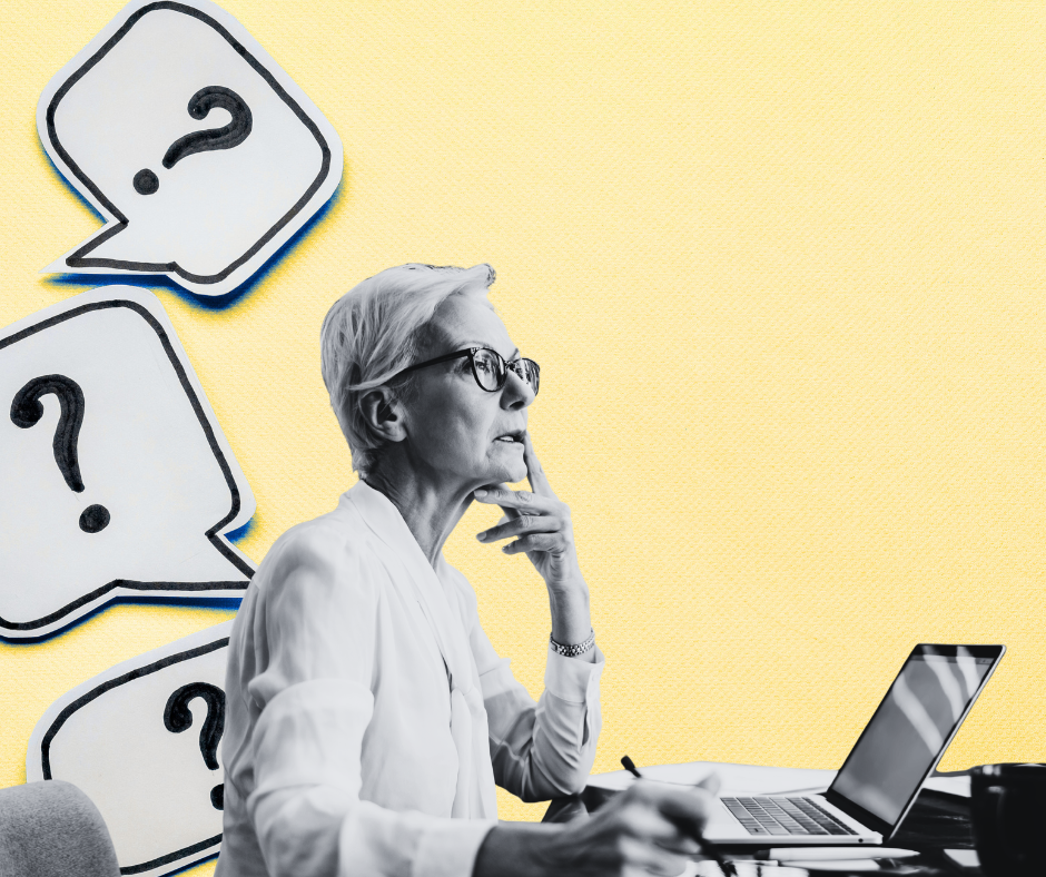 Woman sitting at a computer desk thinking about something.